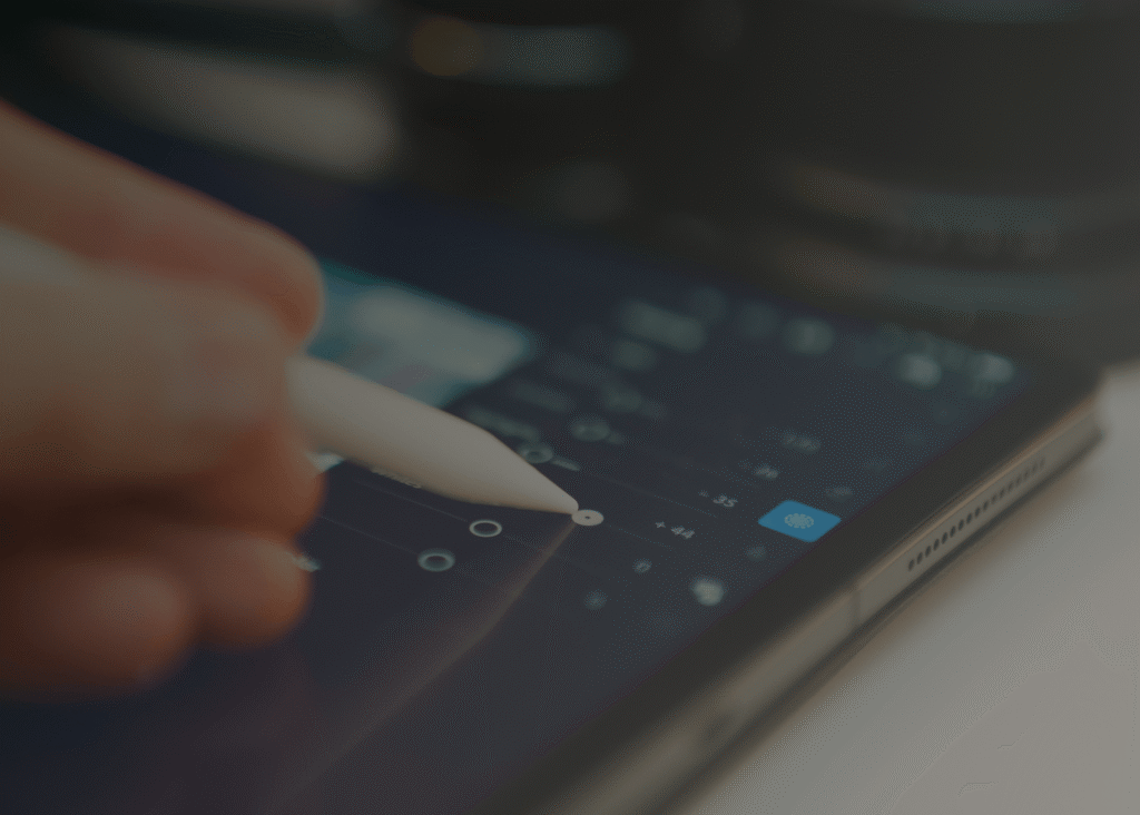 Designer using a digital pen on a tablet for UI/UX and digital product design work.